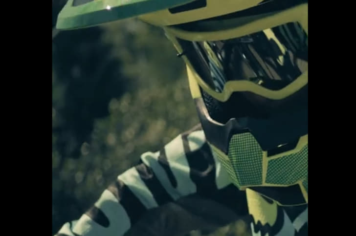 The reflection of Kawasaki's first electric bike seen in the rider's goggles.