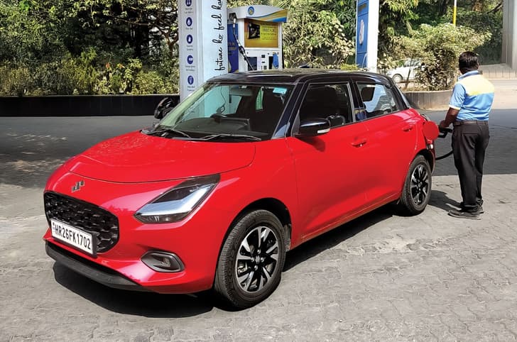 Maruti Swift 2025 long term review fuel filling Maruti Swift 2025 long term review petrol pump fuelling front static