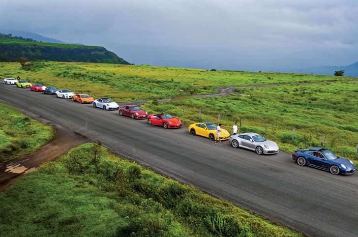 Multiple sportscars parked on the road