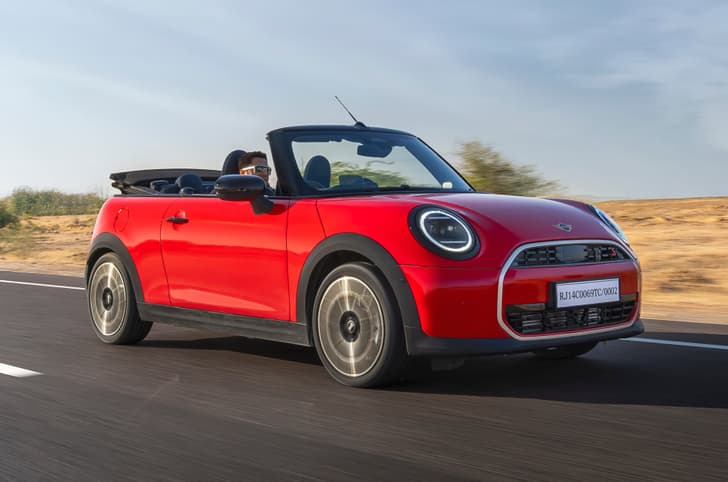 Mini Convertible front right side on road driving Mini Convertible front right side on road driving