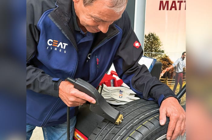 Craftsman making treads on tyre