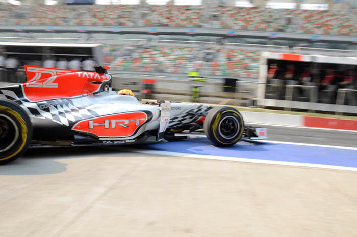 Narain Karthikeyan leaves the HRT pit garage for his first lap of the Buddh Circuit.