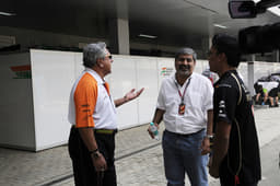 Vijay Mallya and Vicky Chandhok share a light moment in the paddock.