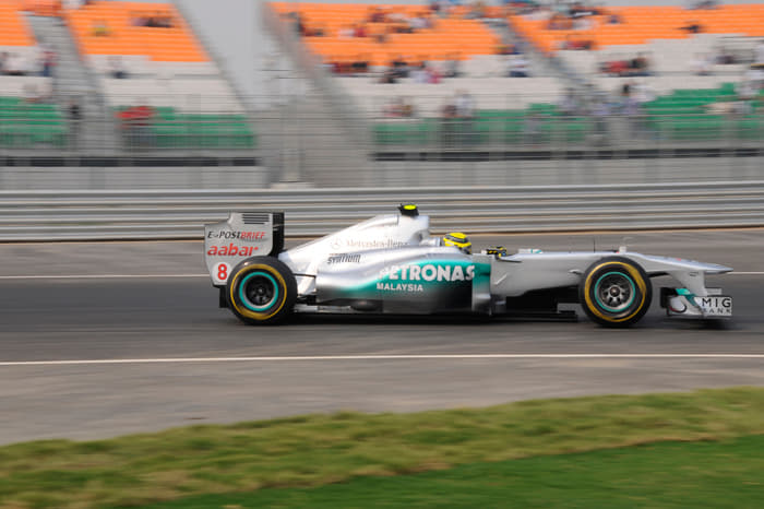 Nico Rosberg of Mercedes GP passes one of the many tricolour spectator stands.