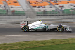 Nico Rosberg of Mercedes GP passes one of the many tricolour spectator stands.