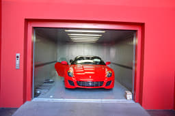 The V12 assembly line is on the first floor. Finished cars make their way to Earth via this lift.