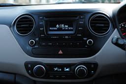 There are small additions to the Xcent’s cabin over the Grand i10’s — the cubbyhole under the centre console gets a closeable lid and it also features automatic climate control. 