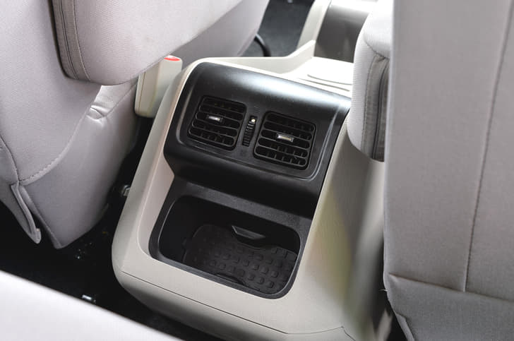 Middle passengers get AC vents and some storage space.