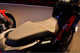It gets a large stepped-saddle with red stitching. 