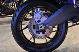 Rear disc brake mounted on an alloy section swingarm. 