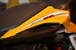 Bajaj Pulsar RS 200 gets grab rails dented on top of the rear panel.