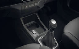 Small cubbyholes behind the gear lever can hold a pair of cups.