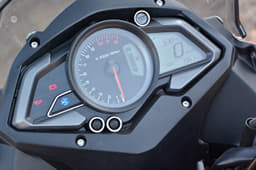 The Bajaj Pulsar AS 150 gets digi-analogue instruments, a useful side-stand engaged sign, clock and a shift-warning light.