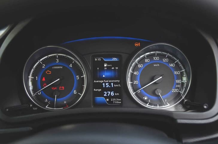 The blue backlight instrument panel stands out in the all-black interior.