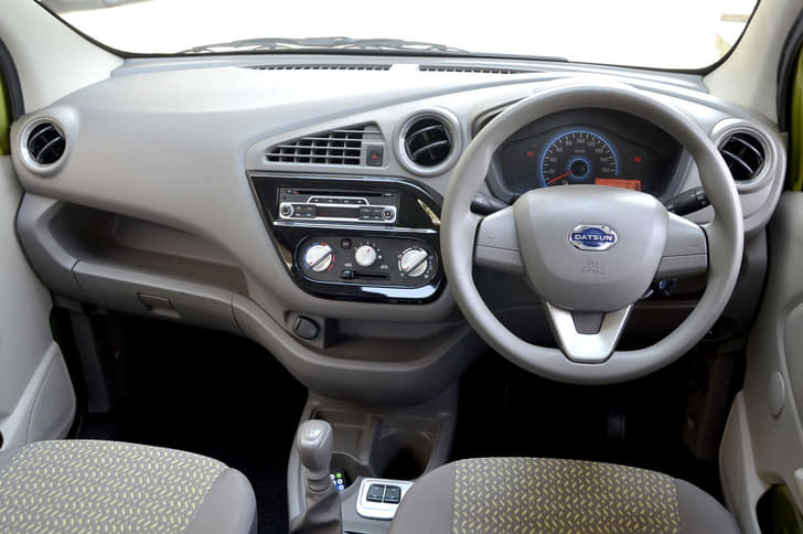 Light colour scheme in Redigo cabin adds to airy ambience; fixed triangular AC vent pointed directly at rear seats.