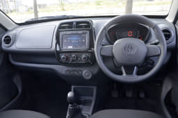 The Kwid’s dash is dominated by the large touchscreen infotainment system though the dull colours are a let-down. It also has more usable storage spaces than the Redigo.