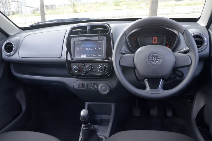 The Kwid’s dash is dominated by the large touchscreen infotainment system though the dull colours are a let-down. It also has more usable storage spaces than the Redigo.