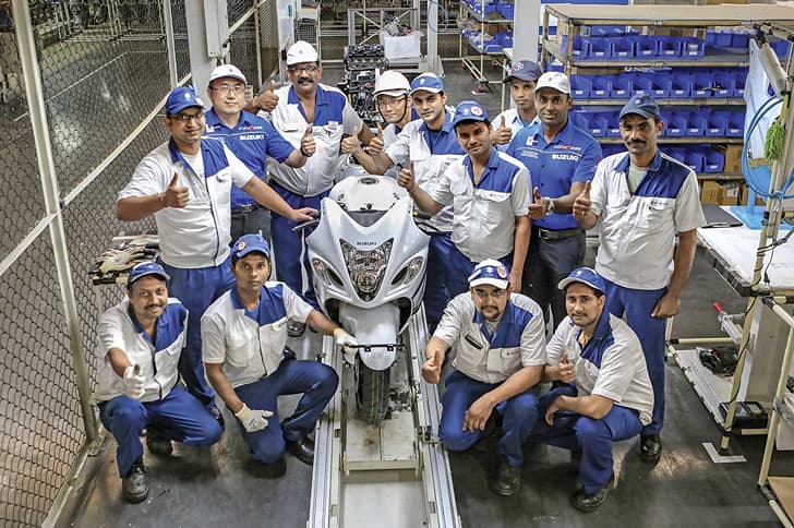 The men in white make the Hayabusa in India. The men in blue, Yoshiaki Harada (left) and Suresh Babu (right), helped get this project off the ground.