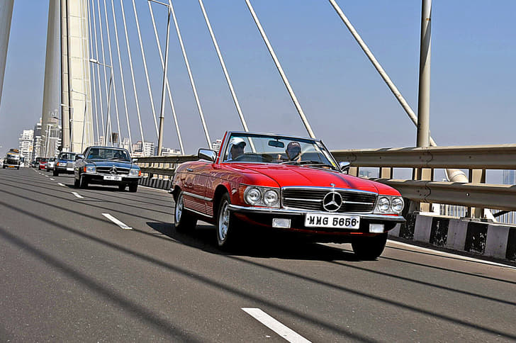 Traffic slows to get a glimpse of 100 rare Mercedes-Benz classics on the city streets.
