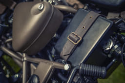 Leather strap with brass buckles on the air box.
