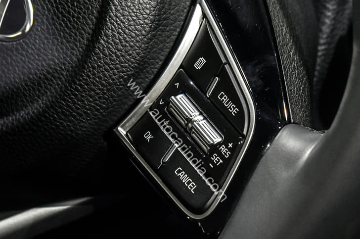 Steering-mounted cruise control.