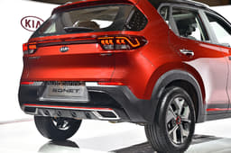 The rear bumper has a silver-finish faux skid plate and faux twin exhaust trims.