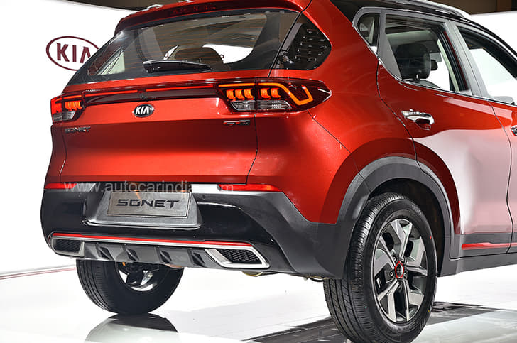 The rear bumper has a silver-finish faux skid plate and faux twin exhaust trims.