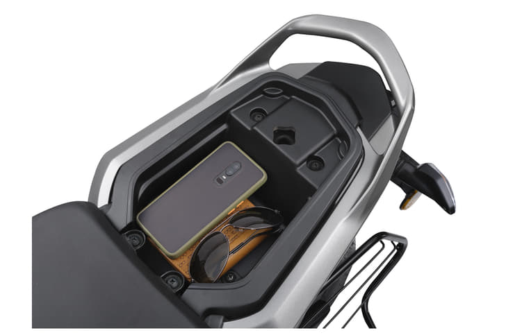 It has storage space located under the pillion seat.