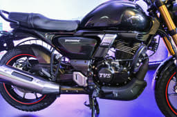 The large, rounded fuel-tank features subtle knee recesses, and the seat is a single-piece design.