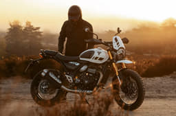 Triumph Scrambler 400 XC white colour right side profile static in field