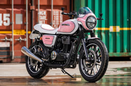 Honda CB350 in a neo-retro avatar with a half-bikini fairing and pink/white colour scheme