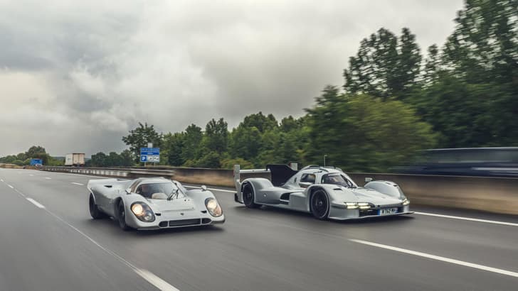 Porsche 963 RSP and 1970s 917 in motion on a track.