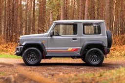 Suzuki Jimny 55th Anniversary Edition side profile in forest