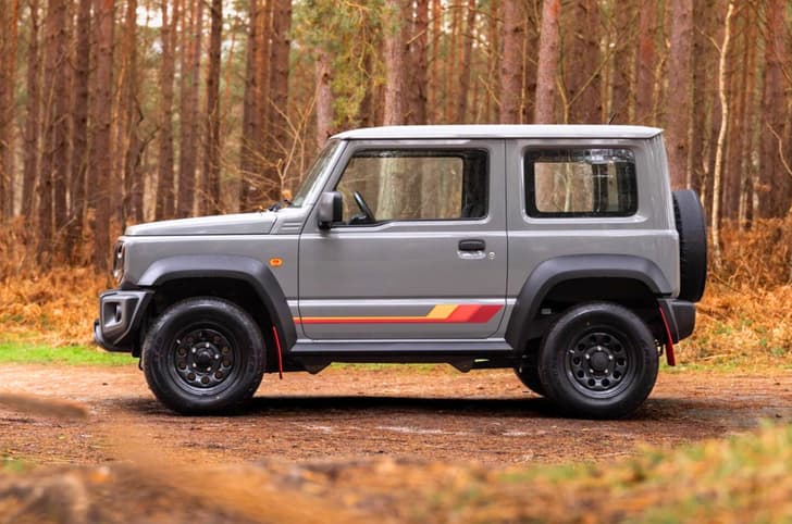 Suzuki Jimny 55th Anniversary Edition side profile in forest