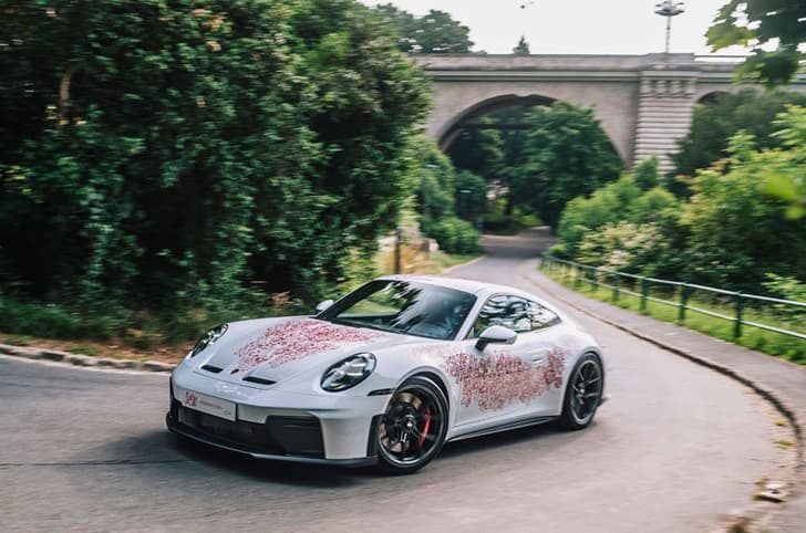 One off Porsche 911 GT3 left side driving around a curve