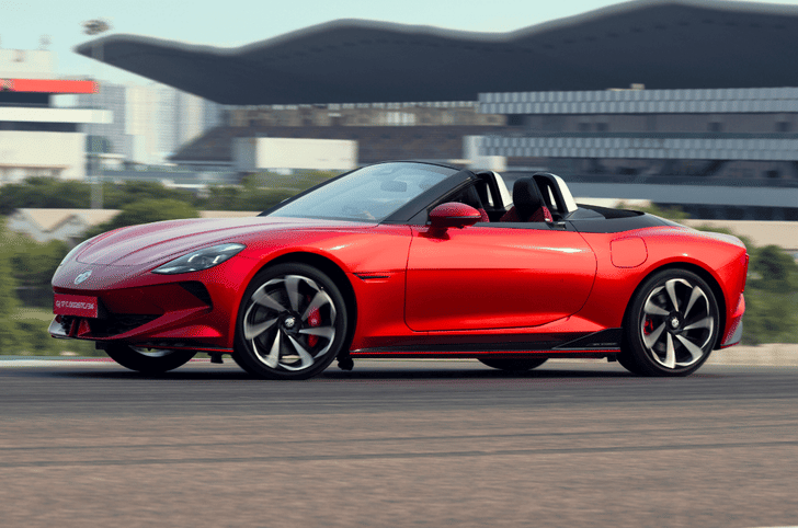 Side profile of red MG Cyberster electric roadster at high speed