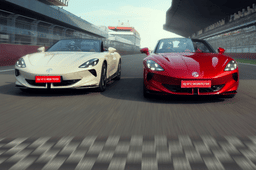 Red and white MG Cyberster EVs racing side by side on circuit