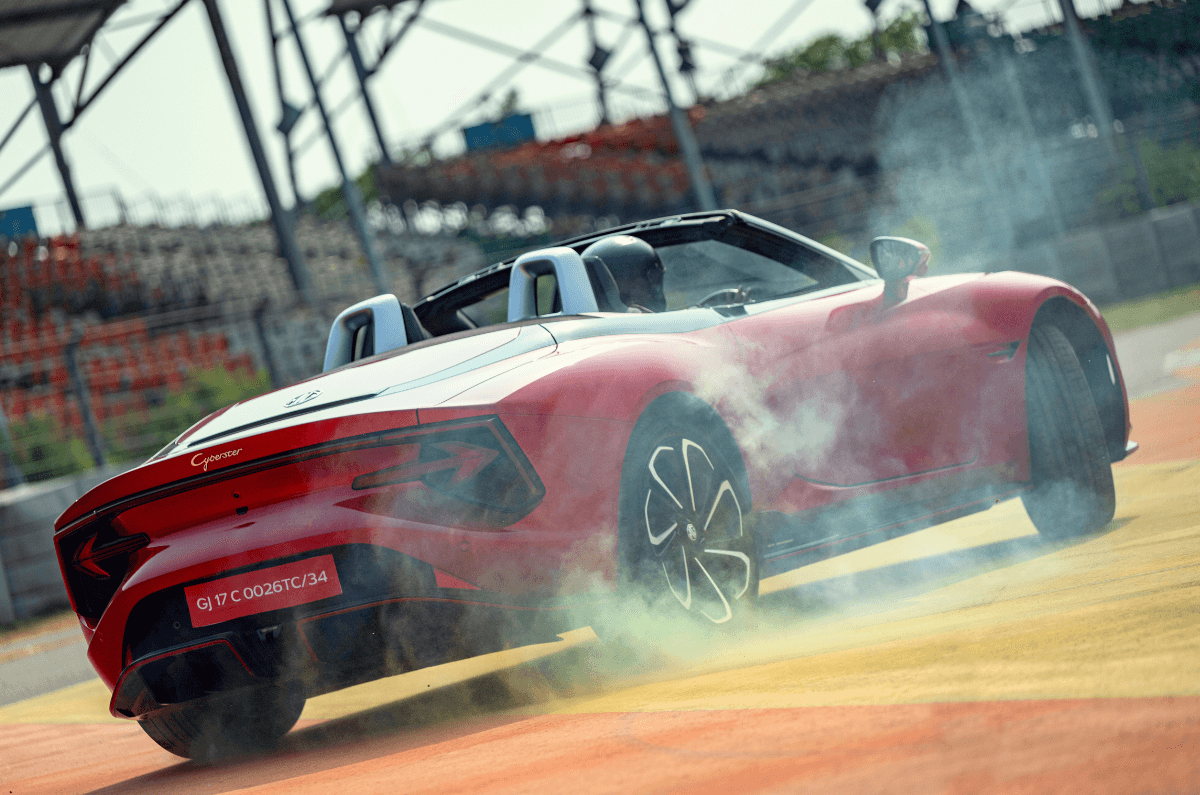 MG Cyberster electric roadster drifting with tyre smoke on race track