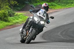 Kawasaki Versys 1100 cornering shot in field