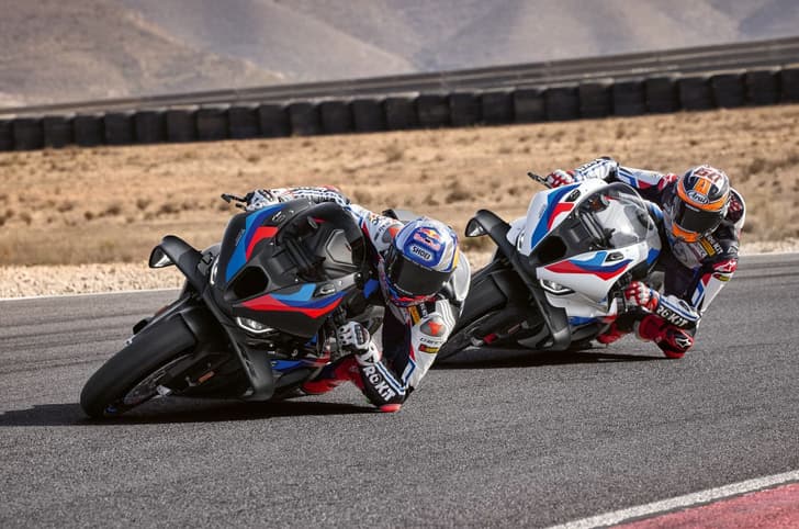 BMW M 1000 RR in black and BMW M 1000 RR in white cornering shot