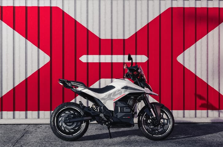 Ultraviolette X47 against white shipping container with large red X