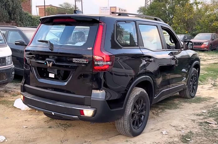 Mahindra Scorpio N Black Edition rear profile showcasing black alloy wheels and roof rails.